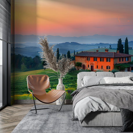 Tuscan landscape wallpaper creating depth in a modern dining room with warm sunset tones