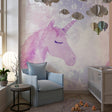 Pink unicorn wallpaper creating a magical atmosphere in a girl's bedroom with soft lighting