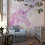 Pink unicorn wallpaper creating a magical atmosphere in a girl's bedroom with soft lighting
