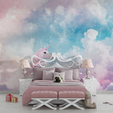 Unicorn wallpaper mural showcased in a bright children's bedroom with white furniture and soft pink accents