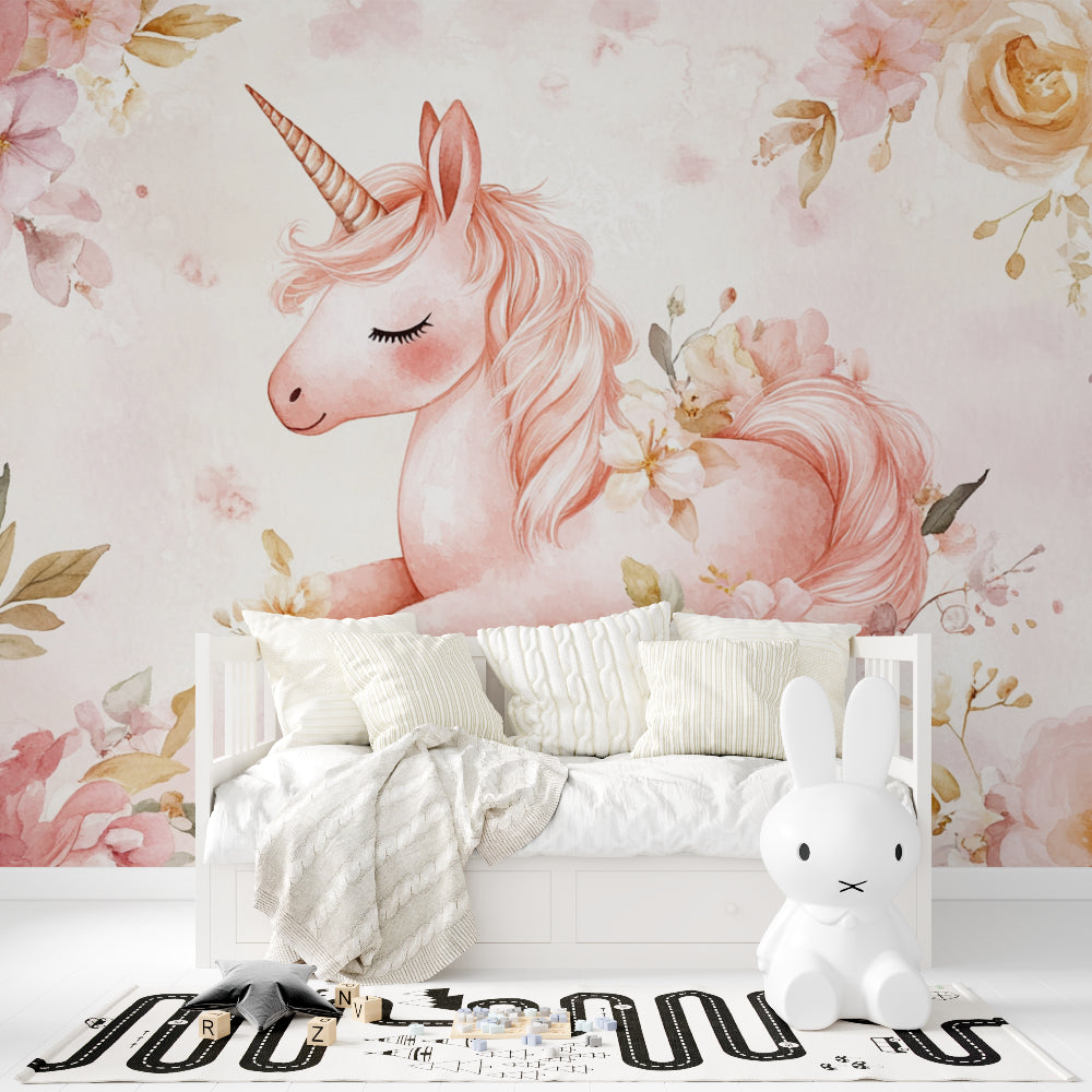 Unicorn wall mural in pink nursery with white furniture showing magical floral design