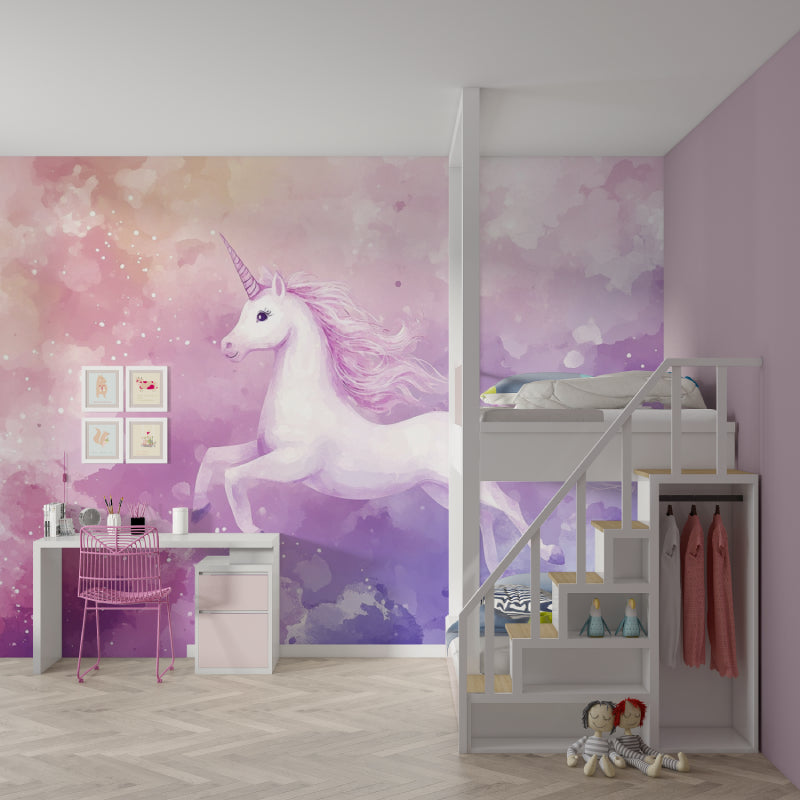 Unicorn wallpaper mural in a bright girl's bedroom, showing the magical pink and purple watercolor design above a white bed