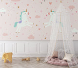 Unicorn wallpaper in a bright kids bedroom with pink curtains and white furniture showing magical ambiance