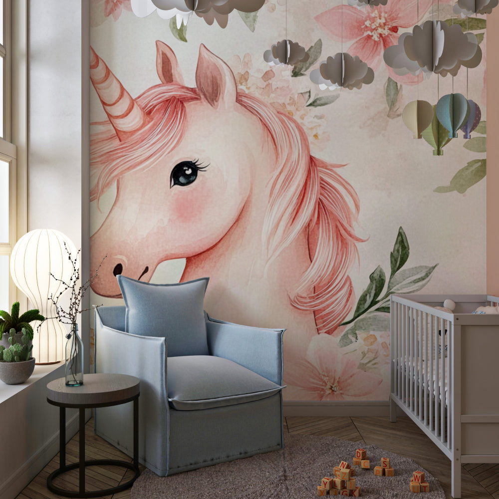 Pink watercolor unicorn design in a baby girl's nursery with white crib