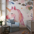 Unicorn wallpaper mural in a bright nursery with white furniture showing the magical watercolor design
