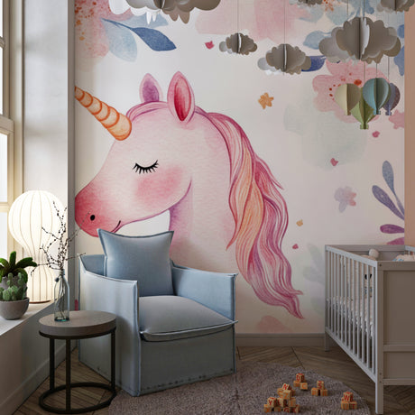 Unicorn wallpaper mural in a bright nursery with white furniture showing the magical watercolor design