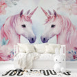 Unicorn wall mural brightening a pink nursery with soft watercolor florals