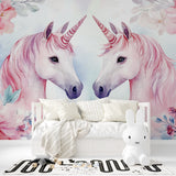 Unicorn wall mural brightening a pink nursery with soft watercolor florals