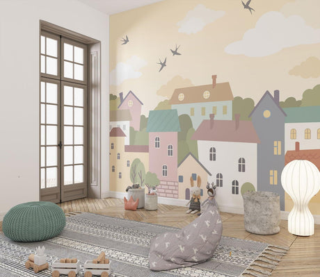 Village wallpaper mural featuring pastel houses shown in a bright modern nursery
