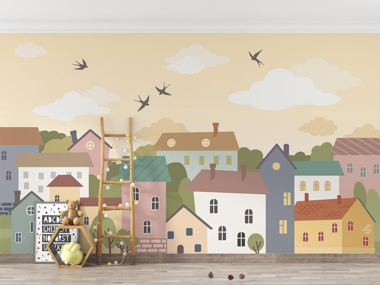 Pastel village mural displayed in a children's playroom with reading nook