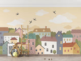 Pastel village mural displayed in a children's playroom with reading nook