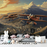 Aviation themed nursery with mountain sunset airplane mural creating warm atmosphere