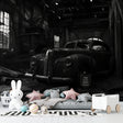 Vintage car wallpaper in modern living room showing black and white industrial design