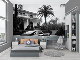 Vintage car wallpaper creating drama in modern living room with grey sofa and minimalist decor