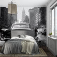 Vintage car wallpaper in modern living room showing black and white urban scene with dramatic lighting