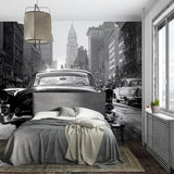Vintage car wallpaper in modern living room showing black and white urban scene with dramatic lighting