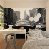Black and white vintage car wallpaper in dining room with city skyline detail