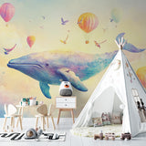 Kids bedroom transformed with dreamy whale mural wallpaper showing playful hot air balloons