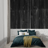 Black wooden wall mural in master bedroom creating cozy atmosphere