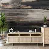 Charred wood wallpaper creating a bold accent wall in a modern living room with minimal furniture and natural light