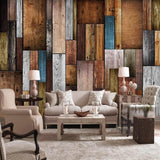 Industrial wood patchwork wallpaper in modern living room with grey sofa and natural light