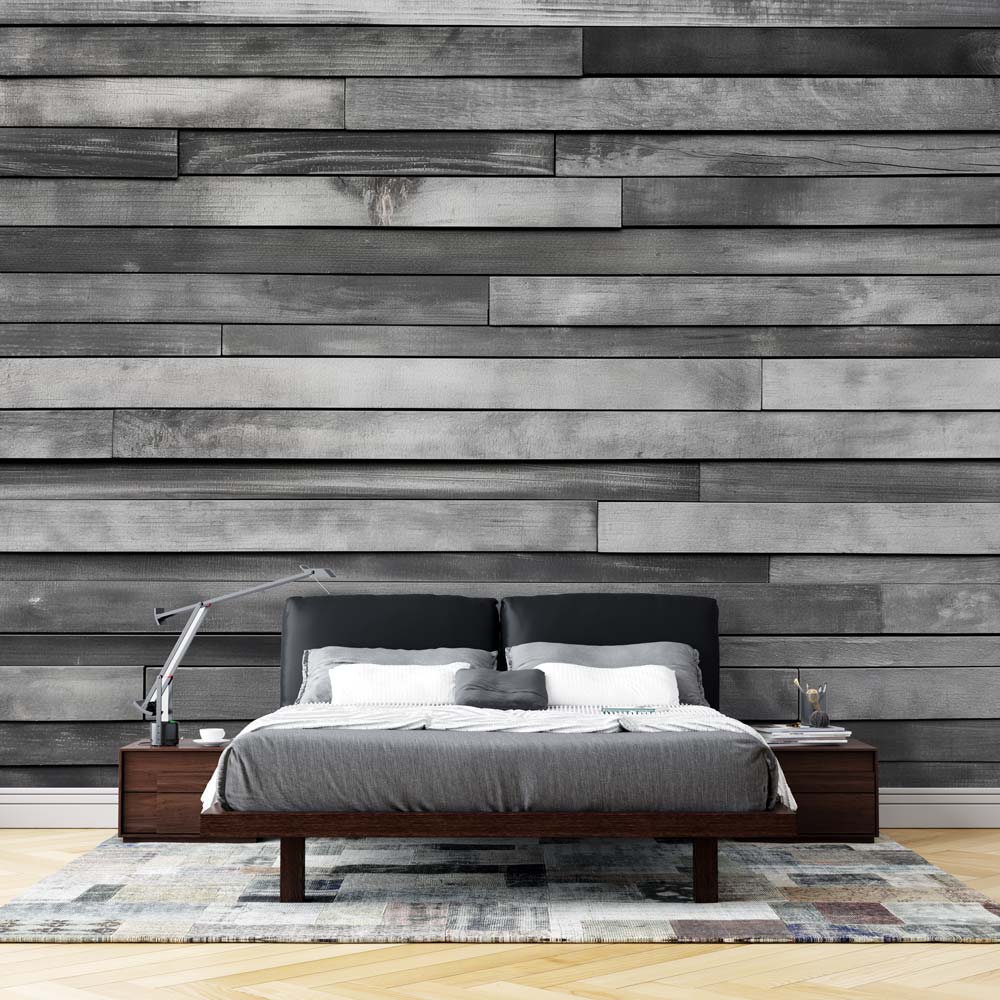 Modern grey wood plank wallpaper creating a sleek accent wall in a minimalist living room with natural light