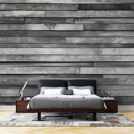 Modern grey wood plank wallpaper creating a sleek accent wall in a minimalist living room with natural light