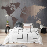 Industrial World Map Wallpaper in living room with bronze accents and grey sofa