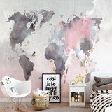 Pink and grey world map wallpaper creating a dreamy atmosphere in a modern child's bedroom
