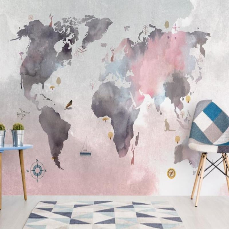 Watercolor world map mural brightening up a cozy home office space with soft pink tones