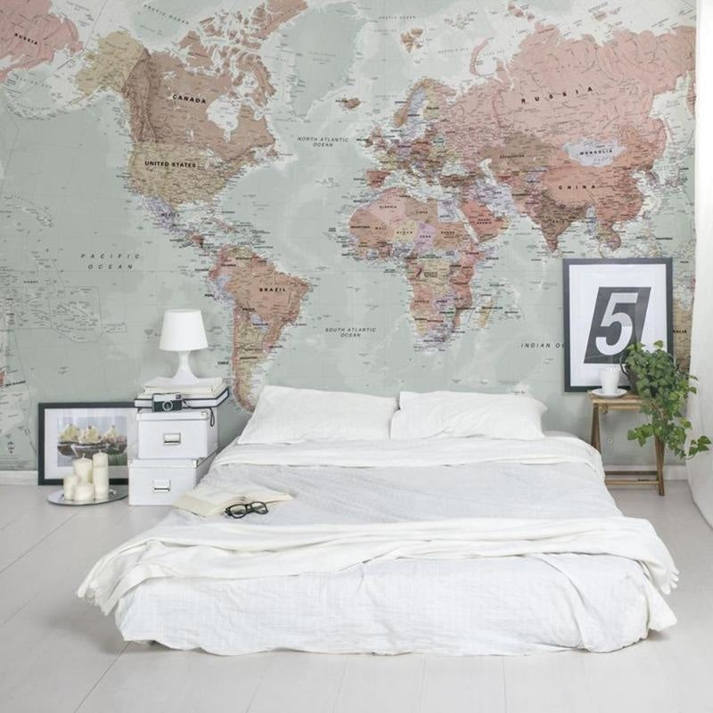 Vintage World Map Wallpaper in modern home office with clean desk setup and natural lighting