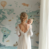 Playroom wall decorated with world map wallpaper showing continents and wildlife