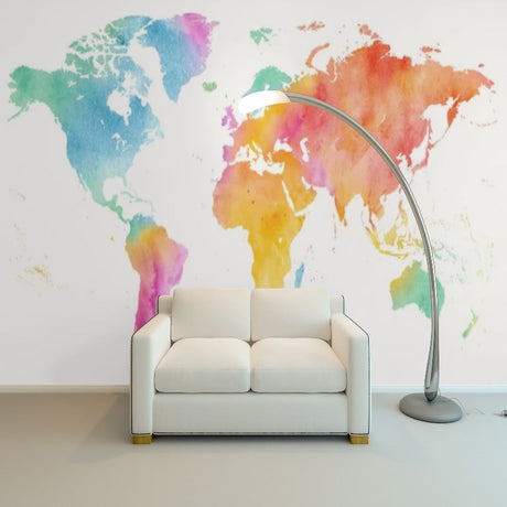Watercolor World Map Mural displayed in modern home office with desk and chair, showing vibrant rainbow continents