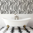 Modern living room featuring striking Zebra print wallpaper mural, showing black and white pattern in contemporary setting